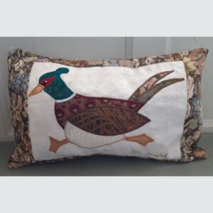 The Sussex Guild Pheasant cushion in tawney colours