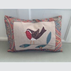 The Sussex Guild Robin cushion in green and red