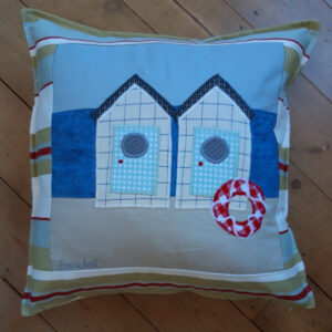 The Sussex Guild Seaside Beach Huts cushion
