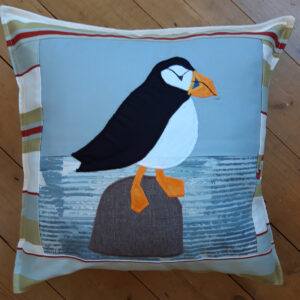 The Sussex Guild Seaside Puffin looking right cushion