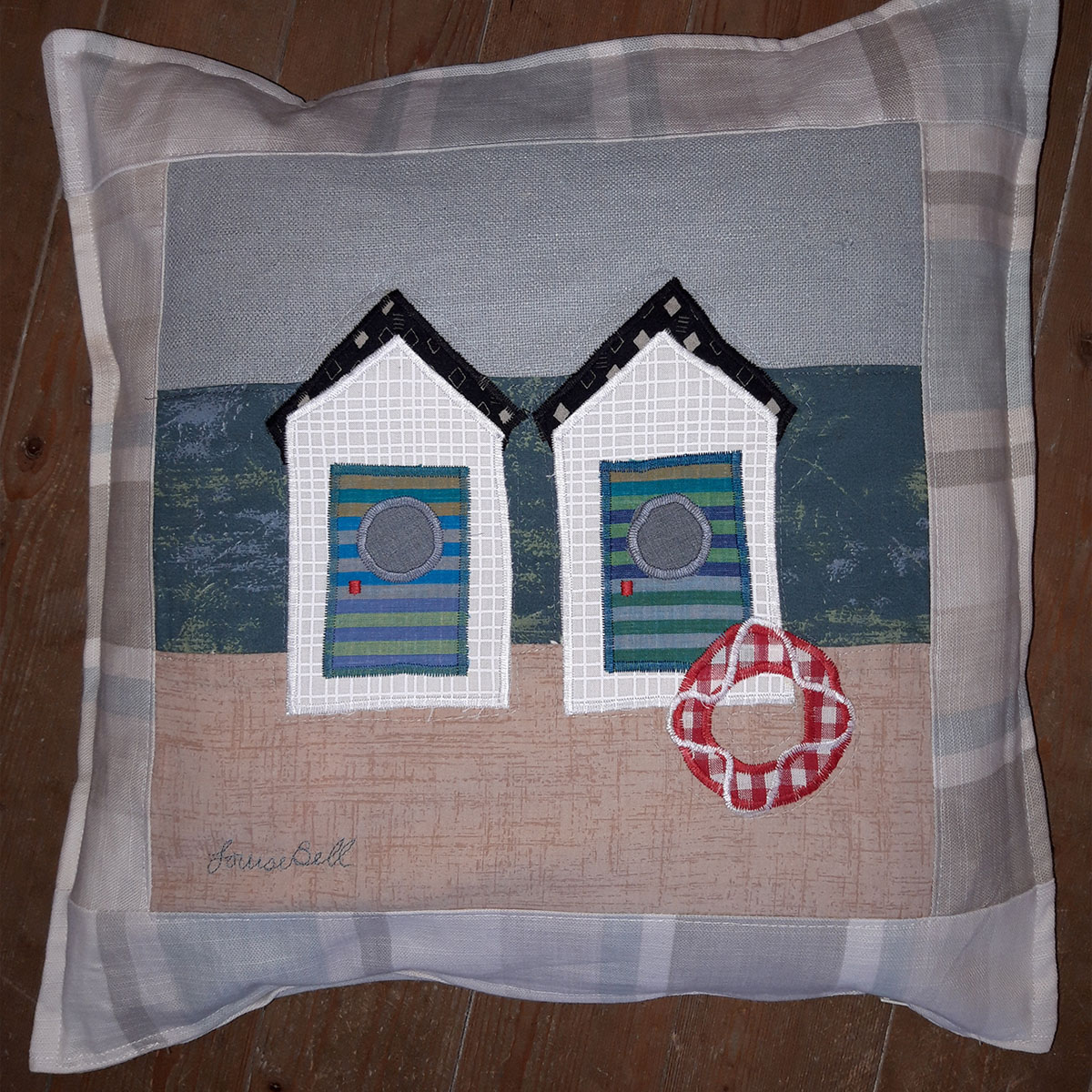 The Sussex Guild Beach Huts cushion