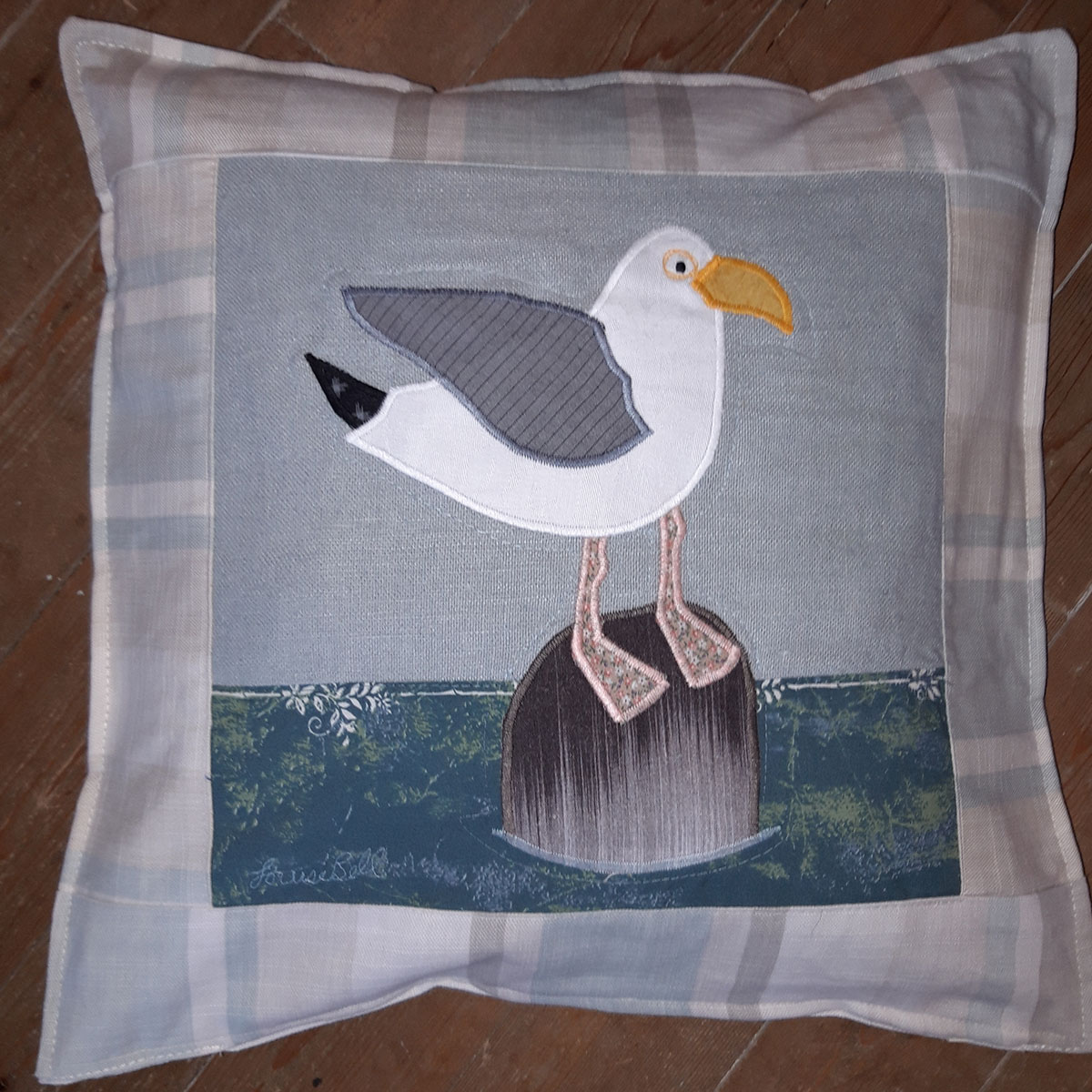 The Sussex Guild Seagull on a rock cushion