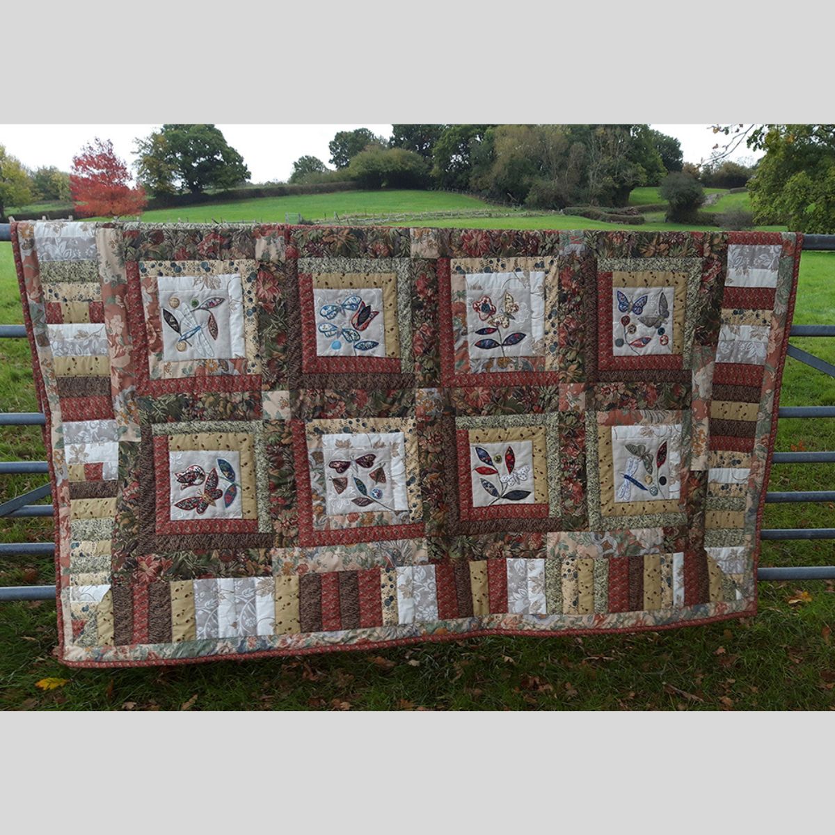 The Sussex Guild Tawney quilt with Butterflies and moths Louise Bell