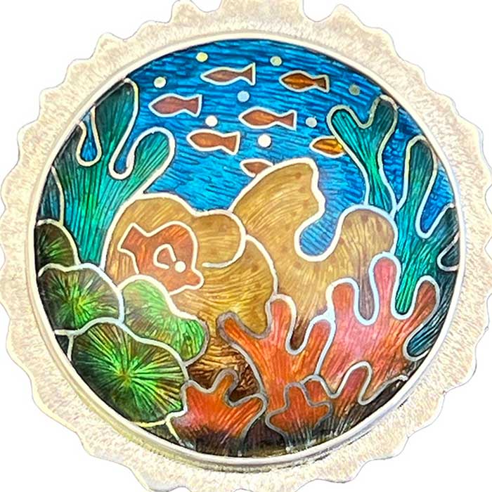 Image of a circular brooch with coral reef design created by Linda Connelly