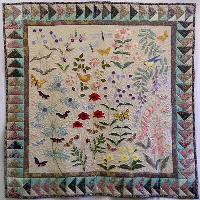 Image of a wild flower quilt created by Louise Bell.